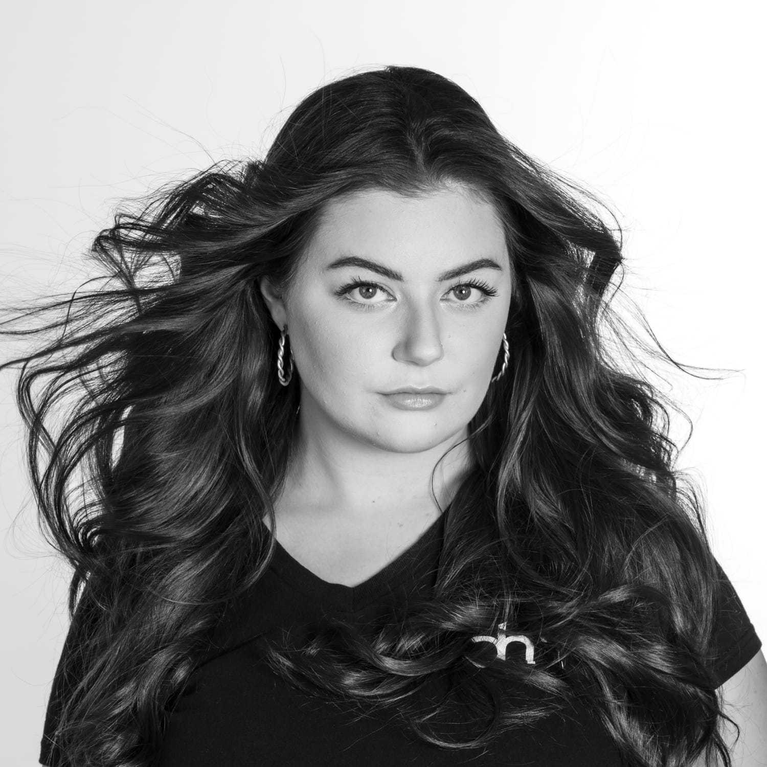 Portrait of Kinlee Perdue, a professional stylist at Dominic Michael Salon, showcasing their expertise and style.